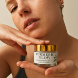 Woman holding a jar of 'Turmeric Glow' face cream with a neutral background