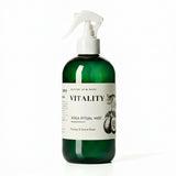 Green bottle of 'Vitality' Yoga Ritual Mist with a white label on a white background