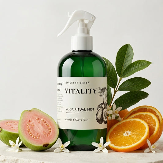Green bottle of 'Vitality' Yoga Ritual Mist with oranges and guava on a light background