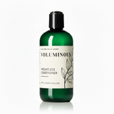 Green bottle of 'Voluminous' weightless conditioner on a white background