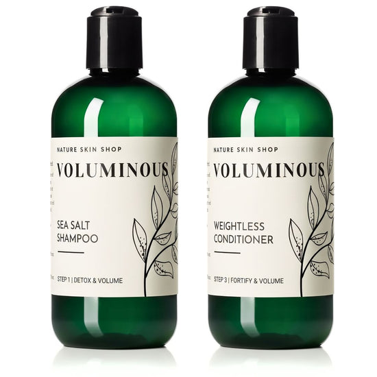 Two dark green bottles of Nature Skin Shop Voluminous hair care products on a white background: Sea Salt Shampoo and Weightless Conditioner, both with black caps and cream labels.