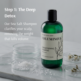 Voluminous shampoo bottle on a marble surface with text about deep detox and sea salt shampoo.